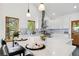 Bright kitchen with white cabinetry, granite countertops, and stainless steel hood vent at 11760 Baca Rd, Conifer, CO 80433