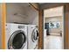Convenient laundry area with modern washer and dryer, adjacent to the kitchen at 11760 Baca Rd, Conifer, CO 80433