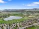Breathtaking aerial shot highlighting the community's beautiful landscapes, mountains, and tranquil lake at 5554 S Ward Way, Littleton, CO 80127