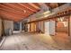 Unfinished basement with exposed ceiling, ductwork, and wooden flooring ready for your design ideas at 5554 S Ward Way, Littleton, CO 80127