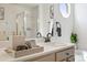 Modern bathroom featuring a vanity with a stylish sink, tasteful decor, and shower at 5554 S Ward Way, Littleton, CO 80127