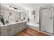 Bright primary bathroom with dual sinks, shower and soaker tub with chrome fixtures at 5554 S Ward Way, Littleton, CO 80127