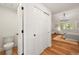 Bedroom featuring closet space and hardwood floors with attached bathroom at 5554 S Ward Way, Littleton, CO 80127