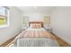 Comfortable bedroom with light hardwood floors, neutral decor and a cozy ambiance at 5554 S Ward Way, Littleton, CO 80127