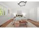 Bright bedroom with hardwood floors, chandelier, natural light, and neutral colors at 5554 S Ward Way, Littleton, CO 80127