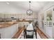 Open dining area with modern lighting, glass table, and views to the back patio at 5554 S Ward Way, Littleton, CO 80127