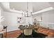 Well-lit dining room with a modern chandelier, a large painting, and comfortable seating at 5554 S Ward Way, Littleton, CO 80127