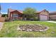 Inviting home with a flower garden in the front yard and a cozy porch with red trim accents at 5554 S Ward Way, Littleton, CO 80127