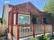 Inviting covered porch with seating, a well-maintained railing, and lovely landscaping at 5554 S Ward Way, Littleton, CO 80127