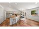 Open kitchen with island, stainless appliances, breakfast bar, and adjacent dining area at 5554 S Ward Way, Littleton, CO 80127