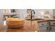 Close up of kitchen island featuring granite countertops and a matte black faucet at 5554 S Ward Way, Littleton, CO 80127
