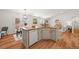 Spacious kitchen with island, dining area, stainless steel dishwasher, and open layout at 5554 S Ward Way, Littleton, CO 80127