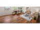 Bright living room features a fireplace, seating, stylish decor, and sleek hardwood floors at 5554 S Ward Way, Littleton, CO 80127