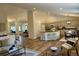 Bright and open-concept living space featuring hardwood floors, a kitchen island, and comfortable seating at 5554 S Ward Way, Littleton, CO 80127