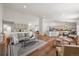 Bright living space with hardwood floors, modern furnishings, and an open concept to the kitchen at 5554 S Ward Way, Littleton, CO 80127