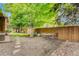 Private backyard with a gravel area, stone pavers, and wooden fence with seating area at 11820 W 66Th Pl # C, Arvada, CO 80004