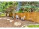 Backyard has two outdoor chairs, small table, and fence at 11820 W 66Th Pl # C, Arvada, CO 80004