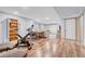 Basement area with workout space, desk area, and sofa with warm wood laminate flooring at 11820 W 66Th Pl # C, Arvada, CO 80004