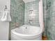 Unique bathroom has green tiling and an updated bathtub at 11820 W 66Th Pl # C, Arvada, CO 80004