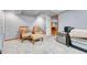 Basement bedroom features plush carpeting, twin beds and comfortable armchairs at 11820 W 66Th Pl # C, Arvada, CO 80004