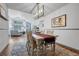 Open-concept dining room with view of living room featuring vaulted ceilings and fireplace at 11820 W 66Th Pl # C, Arvada, CO 80004