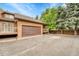 Exterior showcasing the garage, deck, and parking with view to the backyard at 11820 W 66Th Pl # C, Arvada, CO 80004