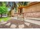 View of the home exterior with wooden and brick accents, complimented by a charming entrance at 11820 W 66Th Pl # C, Arvada, CO 80004