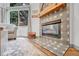 Close-up of a living room fireplace, showing the stylish tile surround and decorative mantel at 11820 W 66Th Pl # C, Arvada, CO 80004