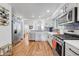 Bright, open kitchen with stainless steel appliances and hardwood floors at 11820 W 66Th Pl # C, Arvada, CO 80004