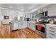 Updated kitchen with stainless appliances, tile backsplash, and open layout at 11820 W 66Th Pl # C, Arvada, CO 80004