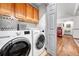 Convenient laundry room with cabinets, washer, and dryer at 11820 W 66Th Pl # C, Arvada, CO 80004