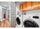 Convenient laundry room with cabinets, washer, and dryer at 11820 W 66Th Pl # C, Arvada, CO 80004