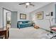 Bright living room with gray walls, a turquoise sofa, and unique decor at 11820 W 66Th Pl # C, Arvada, CO 80004