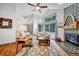 Bright and airy living room featuring a cozy fireplace, modern furniture, and ample natural light at 11820 W 66Th Pl # C, Arvada, CO 80004