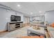 Spacious living room features a plush seating area, TV, and stylish decor at 11820 W 66Th Pl # C, Arvada, CO 80004