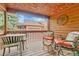Outdoor porch seating area with wood floors and wood ceiling at 11820 W 66Th Pl # C, Arvada, CO 80004