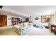 Well-lit basement with recreational area, workout space, and comfortable seating at 10346 E Crestridge Ln, Englewood, CO 80111
