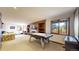 Recreational room with pool table, fireplace, built-in shelves, and view of the backyard at 10346 E Crestridge Ln, Englewood, CO 80111
