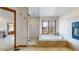 Modern primary bathroom features a glass enclosed shower, soaking tub with outdoor views at 10346 E Crestridge Ln, Englewood, CO 80111