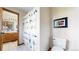 Bathroom featuring a shower with a decorative curtain, toilet, and doorway to the vanity area at 10346 E Crestridge Ln, Englewood, CO 80111