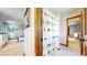 Open bathroom showcases a shower with a decorative curtain and seamless entry to the bedroom space at 10346 E Crestridge Ln, Englewood, CO 80111