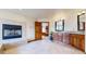 Bathroom showcasing a fireplace, soaking tub, and granite-topped vanity at 10346 E Crestridge Ln, Englewood, CO 80111
