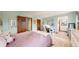 A serene bedroom with hardwood doors, creating a peaceful and inviting space with a well-lit desk area at 10346 E Crestridge Ln, Englewood, CO 80111