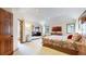 Spacious main bedroom features a bed, sitting area, and ensuite bathroom, blending relaxation and convenience at 10346 E Crestridge Ln, Englewood, CO 80111