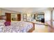 Expansive bedroom boasting a bed and access to both a bathroom and staircase to other levels at 10346 E Crestridge Ln, Englewood, CO 80111