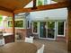 View of an outdoor deck with a dining area, a built-in grill, and access to the house through sliding glass doors at 10346 E Crestridge Ln, Englewood, CO 80111