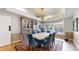 Elegant dining room with stylish chandelier, large window, and a beautiful display cabinet at 10346 E Crestridge Ln, Englewood, CO 80111
