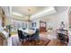Elegant dining room with marble table, plush chairs, and a decorative area rug near bright bay window at 10346 E Crestridge Ln, Englewood, CO 80111