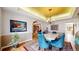 Elegant dining room featuring a luxurious chandelier and seating for six at 10346 E Crestridge Ln, Englewood, CO 80111