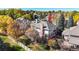 Aerial view of a home with a well-maintained yard, mature trees, and a fenced backyard showcasing its curb appeal at 10346 E Crestridge Ln, Englewood, CO 80111